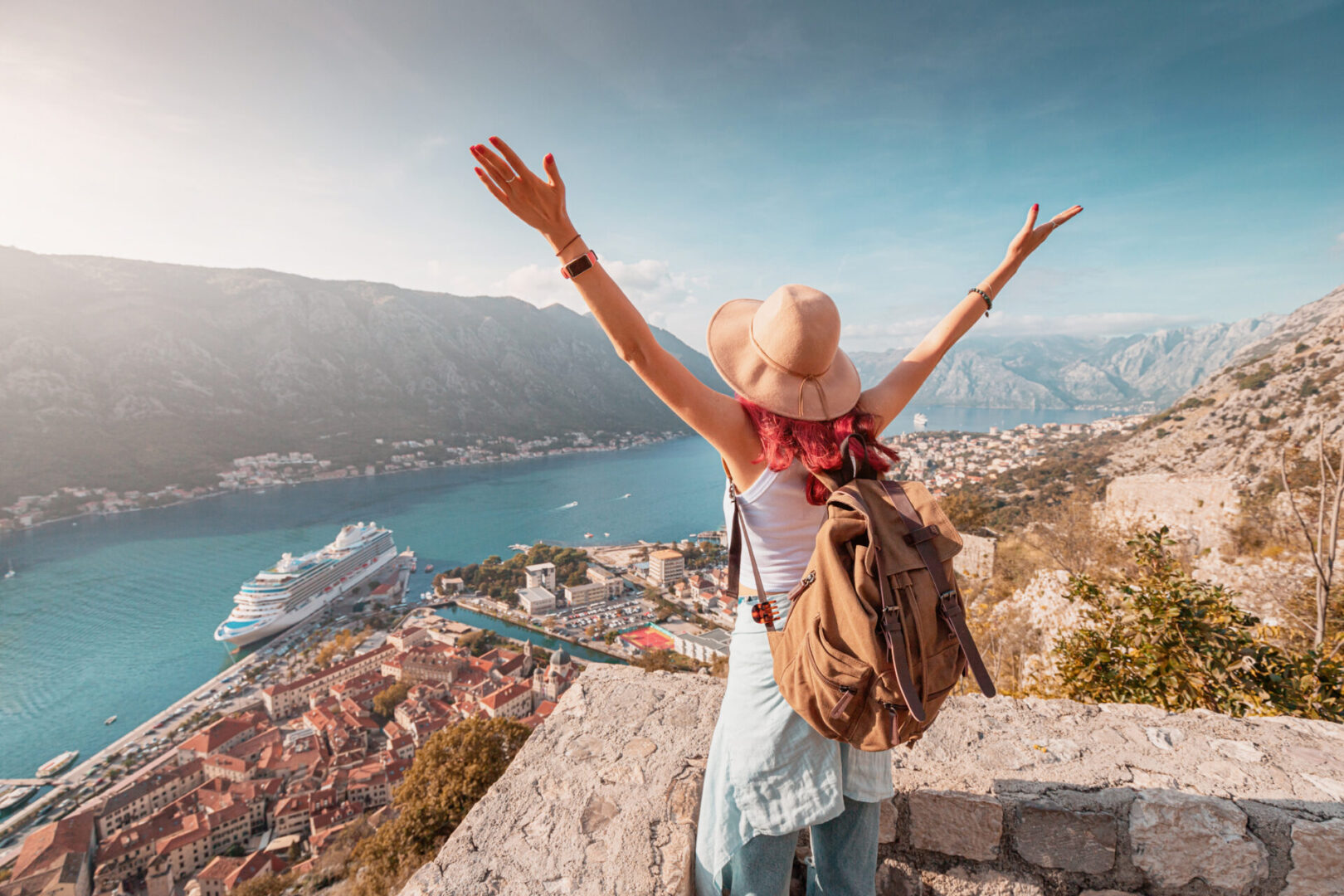 Person celebrating scenic bay view with cruise.