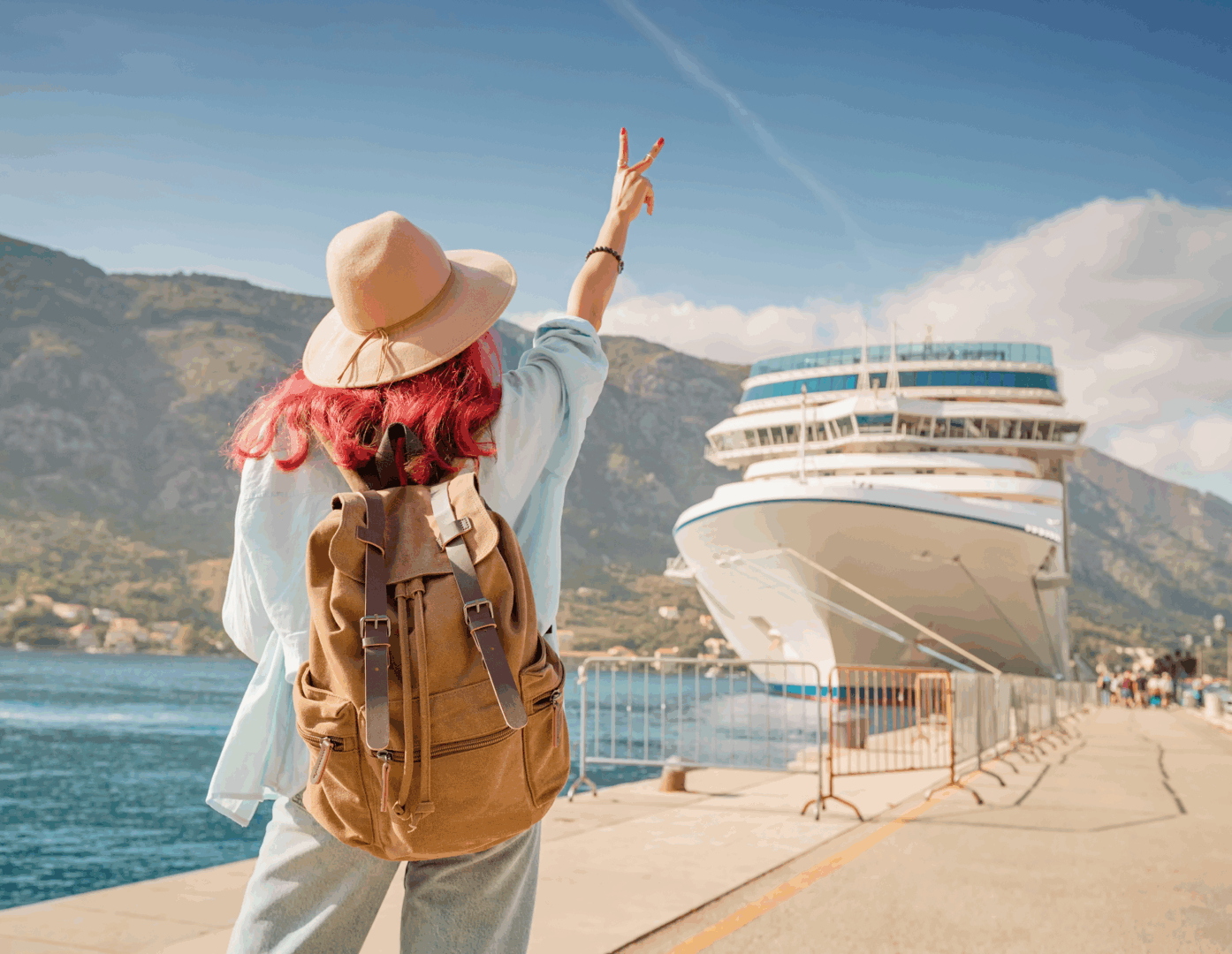 Traveler waving at docked cruise ship.